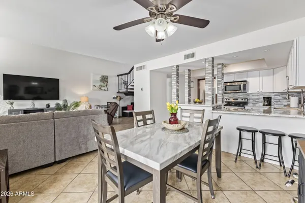 a view of a patio with couches and potted plants