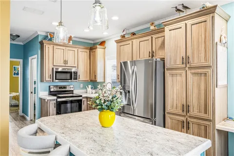 a kitchen with stainless steel appliances granite countertop a refrigerator and a stove top oven