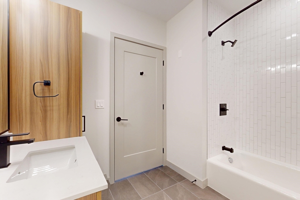 80 Rugg Road, Unit 1311 Boston, MA 02134 - Photo 9 of 20 a bathroom with a bathtub and a shower