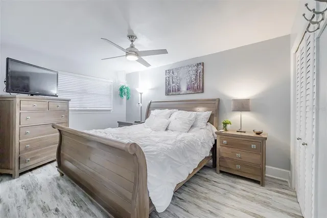 a bedroom with a bed and a tv on the dresser