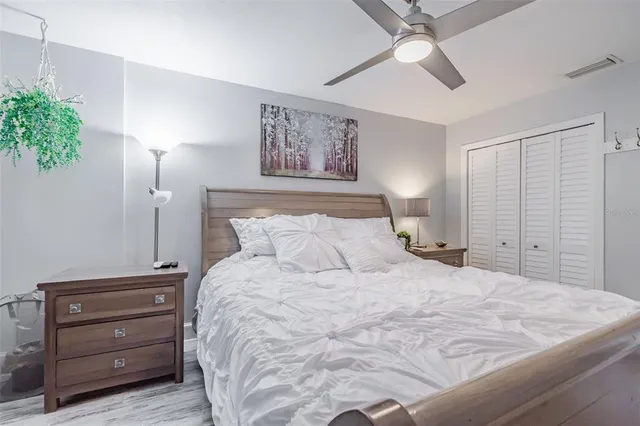 a bedroom with a bed and a painting on the wall