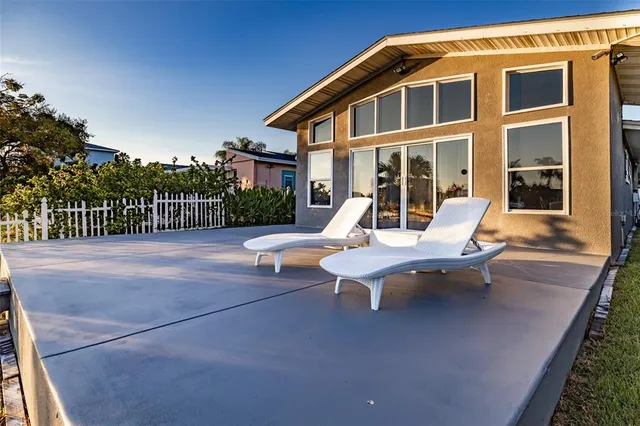 a view of a patio with a table and chairs