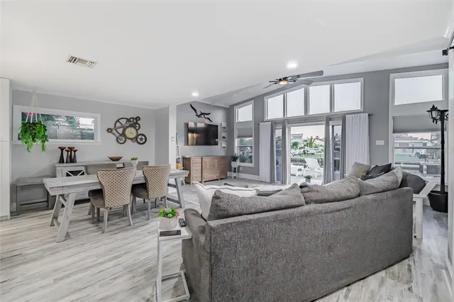 a living room with furniture wooden floor and a large window