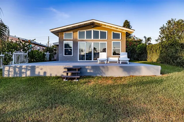 a front view of a house with a yard table and chairs