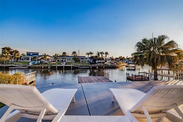 a balcony with chairs and a table