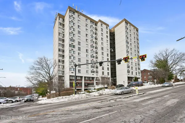 a view of a tall building next to a road