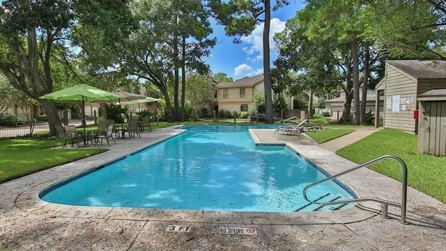 a view of a house with swimming pool and sitting area