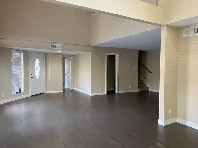 an empty room with wooden floor and closet