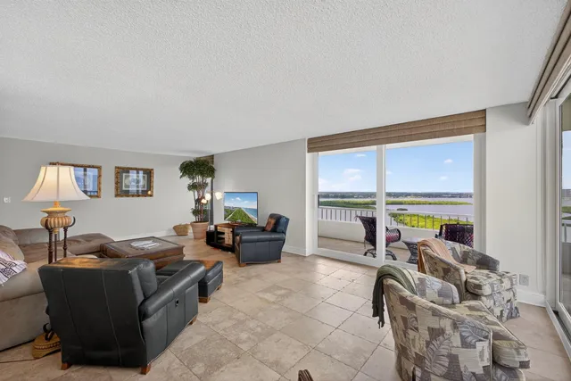 a swimming pool with outdoor seating and outdoor shower