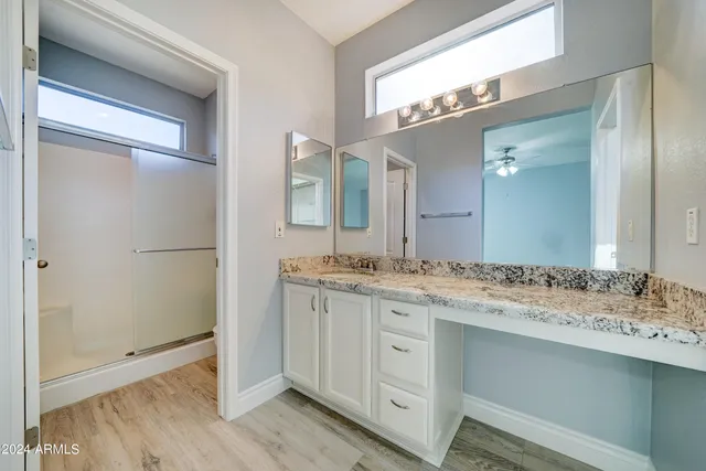 a bathroom with a granite countertop sink mirror and a