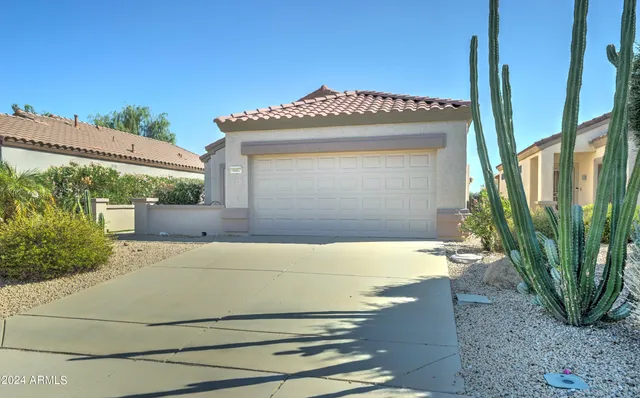 a view of a house with a wooden fence