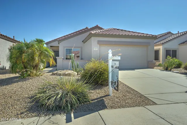 a view of a house with a small yard and plants