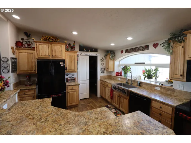 a living room with furniture a chandelier and a flat screen tv