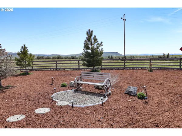 a backyard of a house with barbeque oven