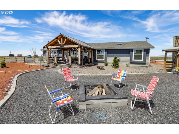 a living room with furniture a flat screen tv and kitchen view