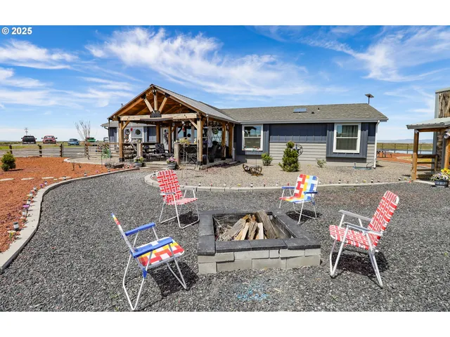 a living room with furniture a flat screen tv and kitchen view