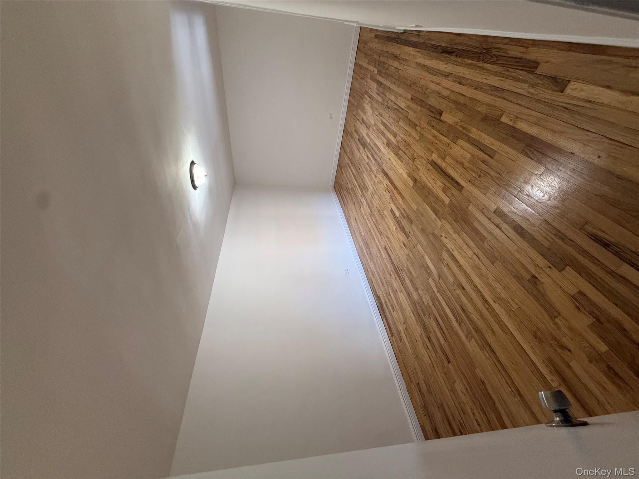 83-40 Austin Street, Unit 3U Queens, NY 11415 - Photo 8 of 8 a view of empty room with wooden floor