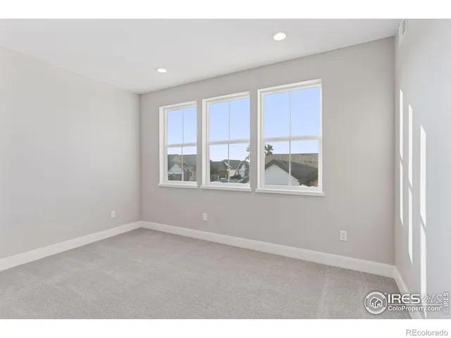 a living room with furniture a flat screen tv and white walls