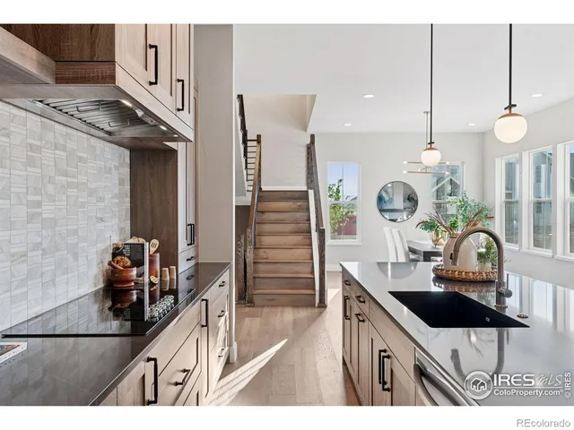 a large kitchen with kitchen island a large counter top a sink a stove and a refrigerator