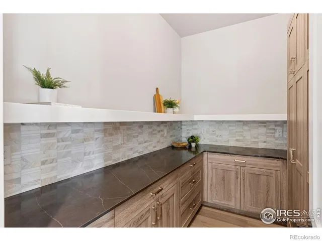 a dining room with furniture and a large window