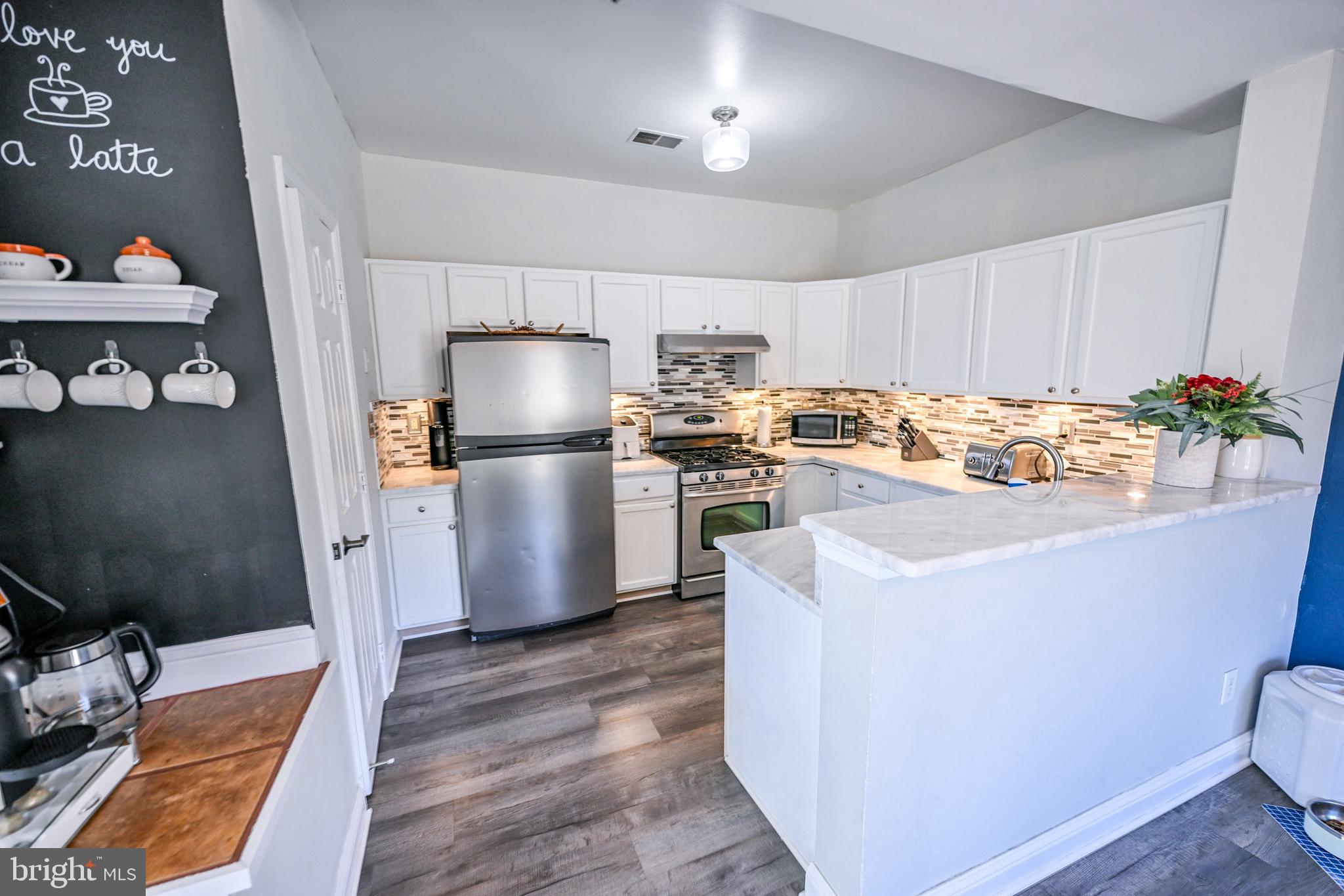 8727 Grape Arbor Way Odenton, MD 21113 - Photo 11 of 49 a kitchen with a sink and a stove top oven