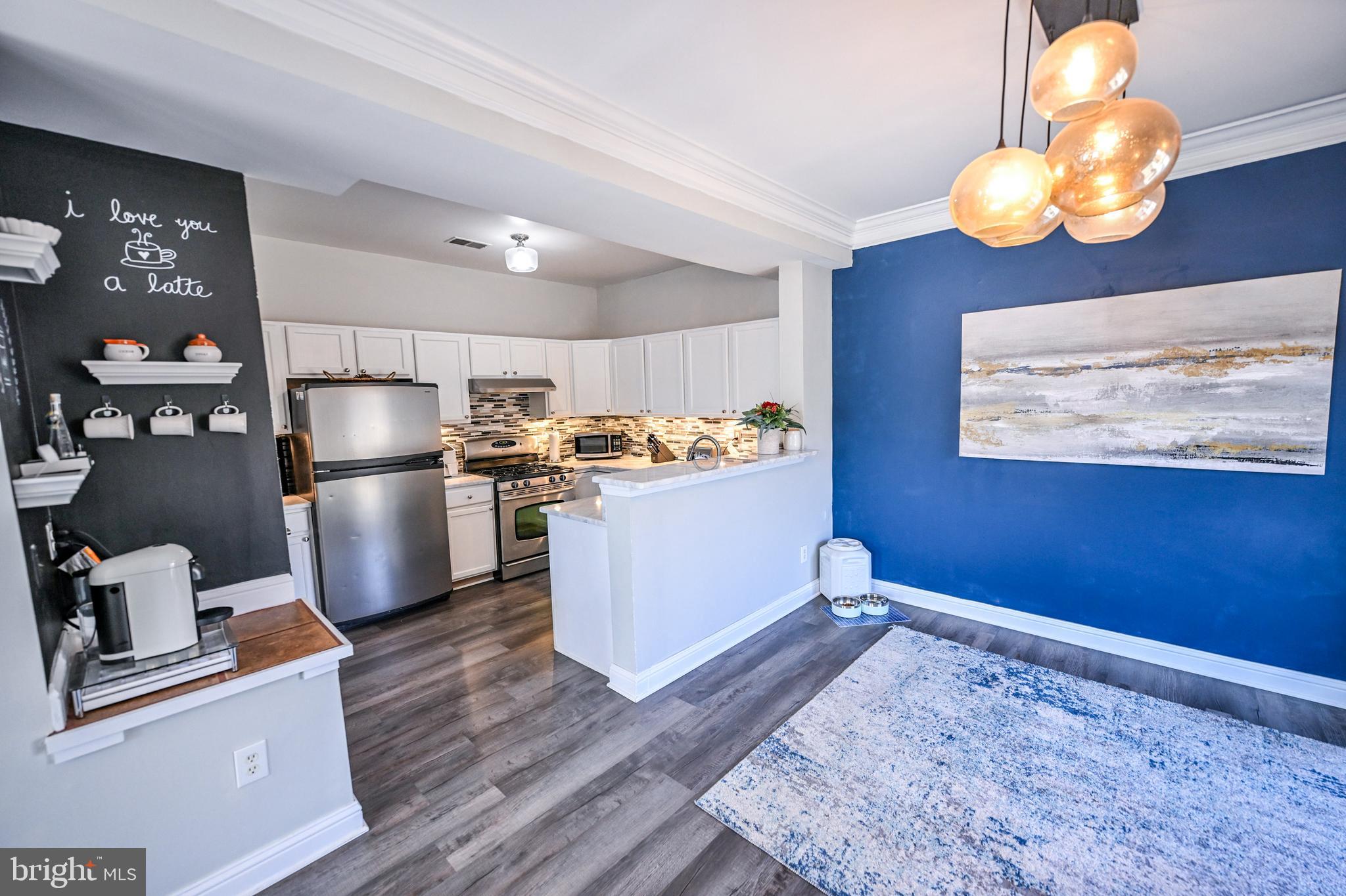 8727 Grape Arbor Way Odenton, MD 21113 - Photo 16 of 49 a kitchen with refrigerator and wooden floor