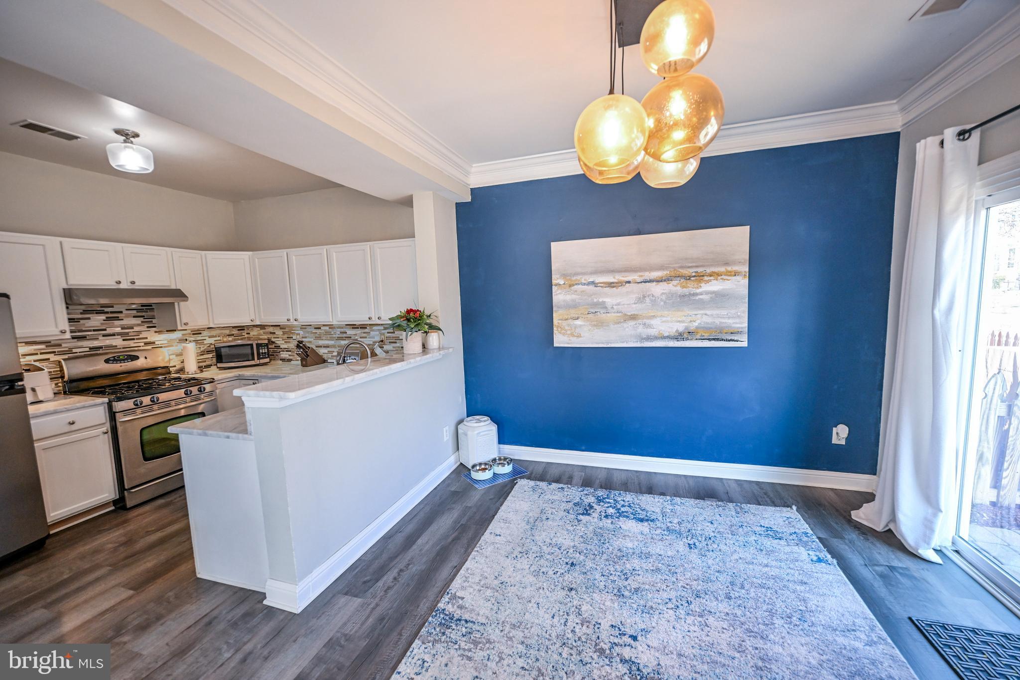 8727 Grape Arbor Way Odenton, MD 21113 - Photo 17 of 49 a kitchen with stainless steel appliances granite countertop a sink a stove a refrigerator and a window