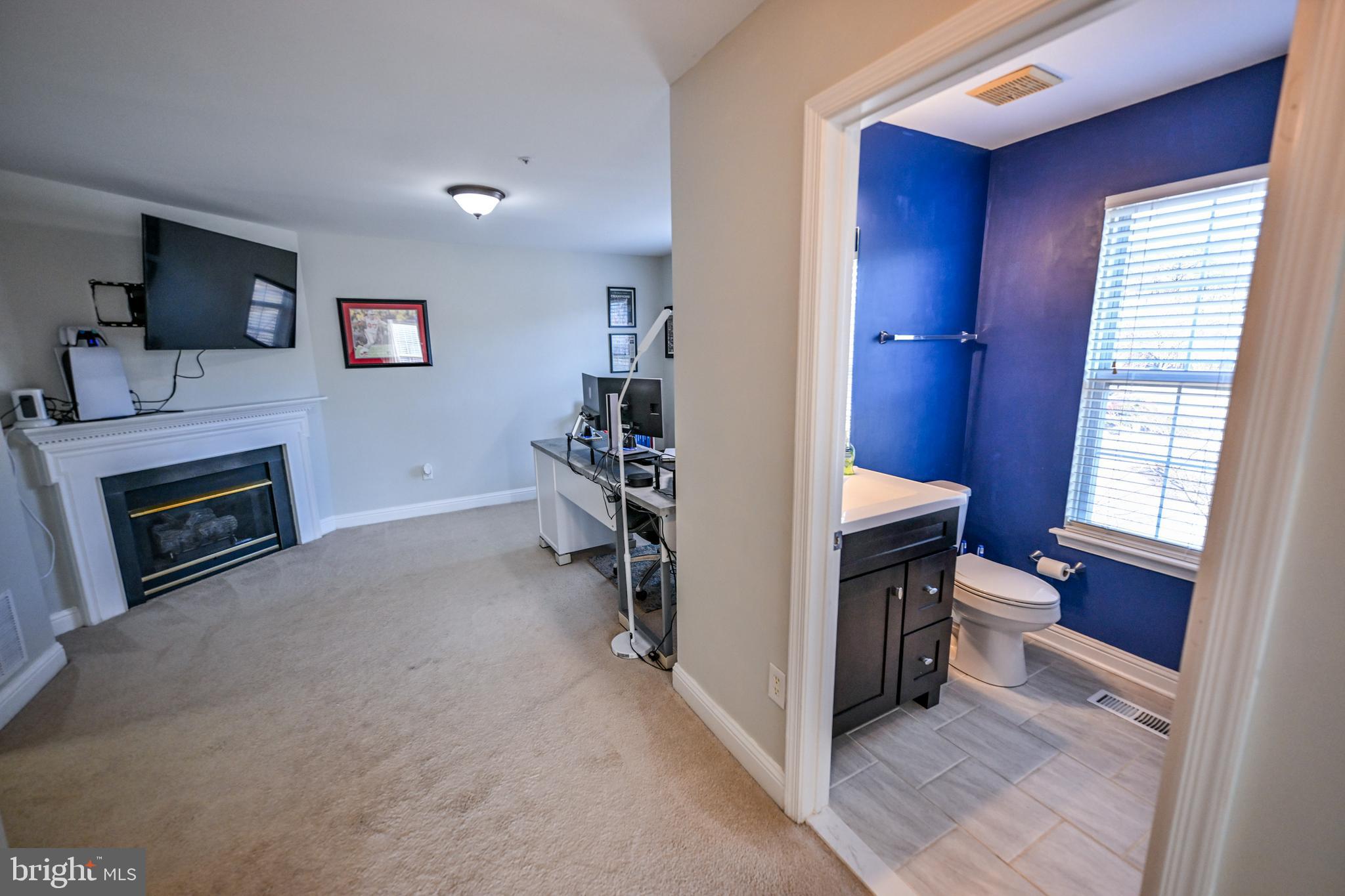 8727 Grape Arbor Way Odenton, MD 21113 - Photo 22 of 49 a view of a hallway with furniture and a fireplace