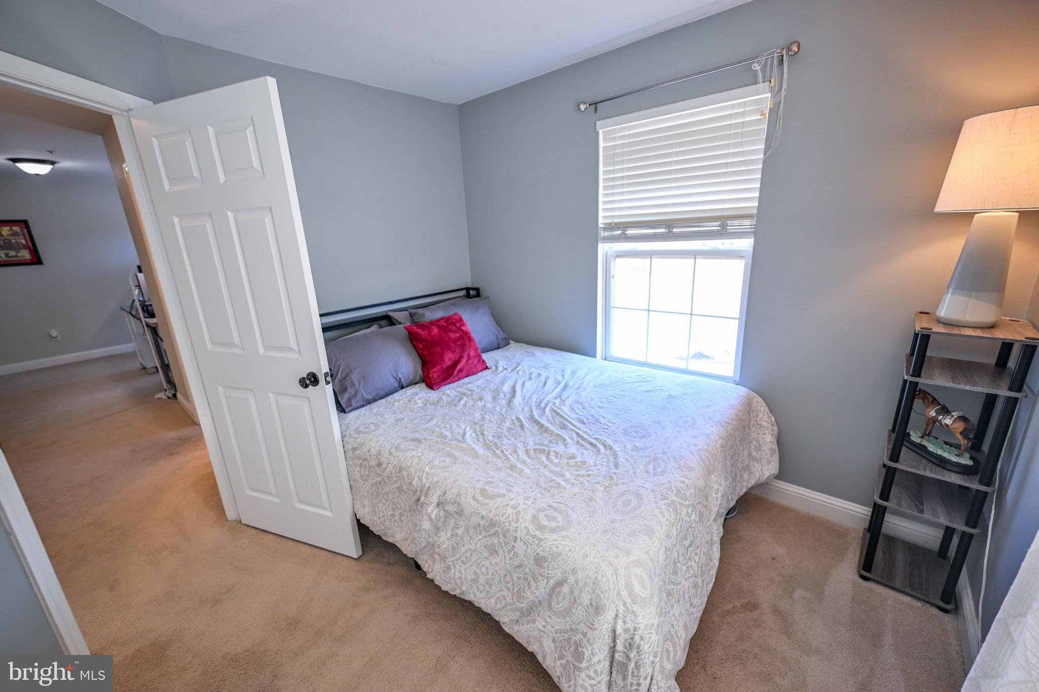 8727 Grape Arbor Way Odenton, MD 21113 - Photo 31 of 49 a bedroom with a bed and a flat tv screen on a dresser