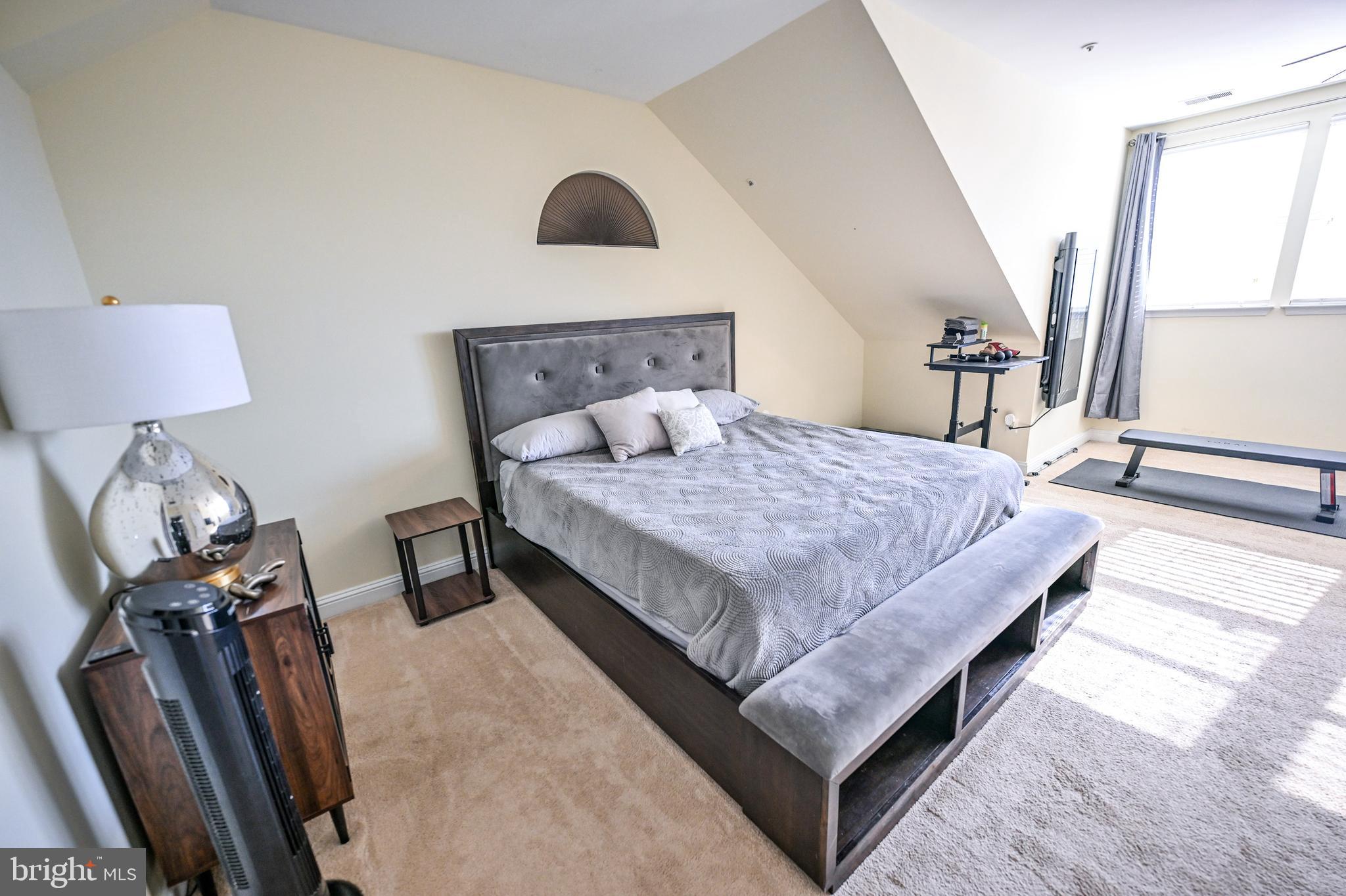 8727 Grape Arbor Way Odenton, MD 21113 - Photo 34 of 49 a bedroom with a bed and a lamp on dresser