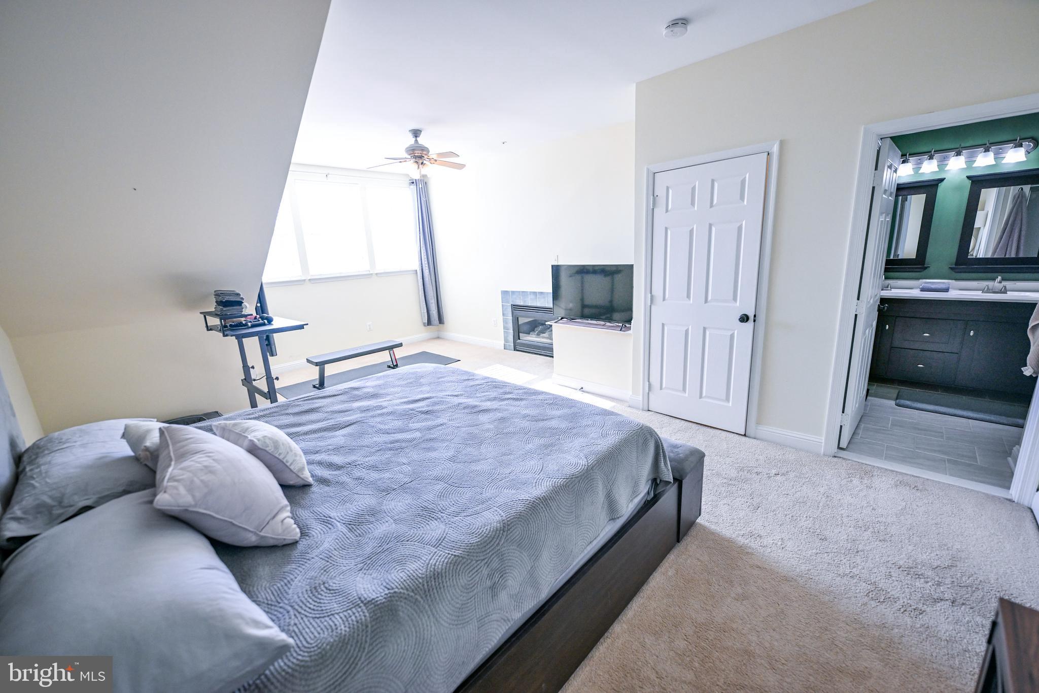 8727 Grape Arbor Way Odenton, MD 21113 - Photo 35 of 49 a bedroom with a bed and a chandelier