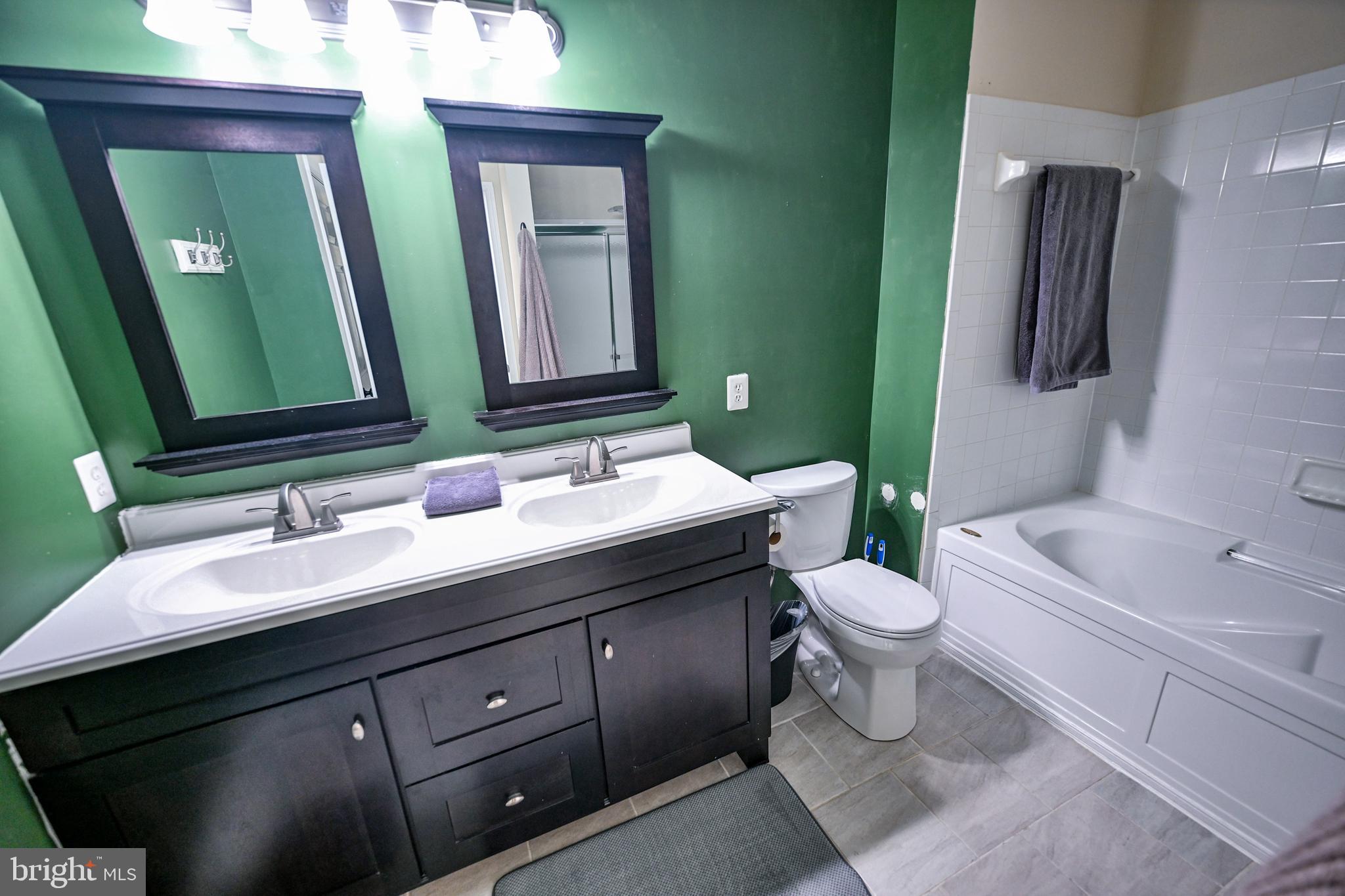 8727 Grape Arbor Way Odenton, MD 21113 - Photo 38 of 49 a bathroom with a double vanity sink toilet and mirror