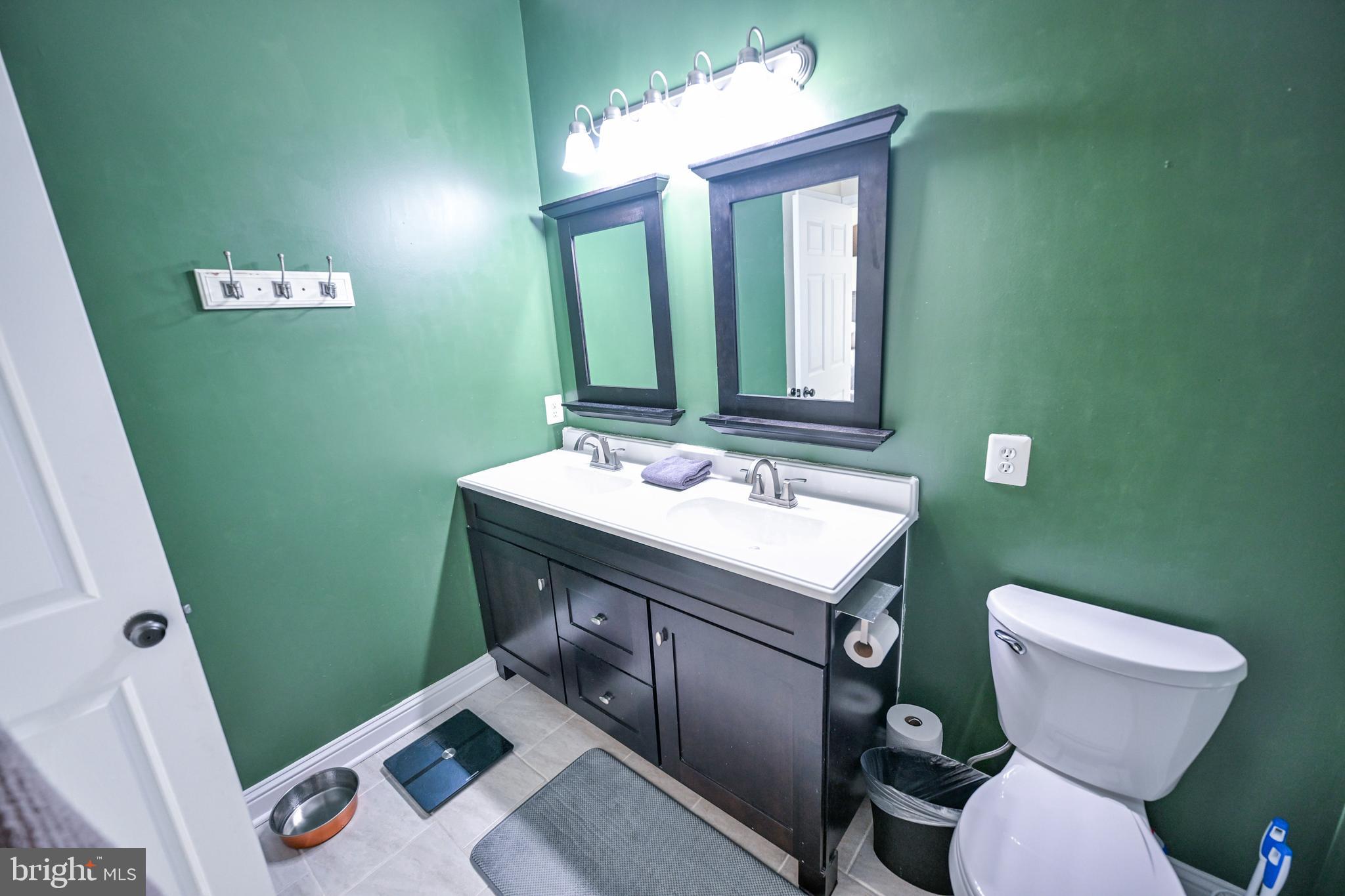 8727 Grape Arbor Way Odenton, MD 21113 - Photo 40 of 49 a bathroom with a toilet sink and mirror
