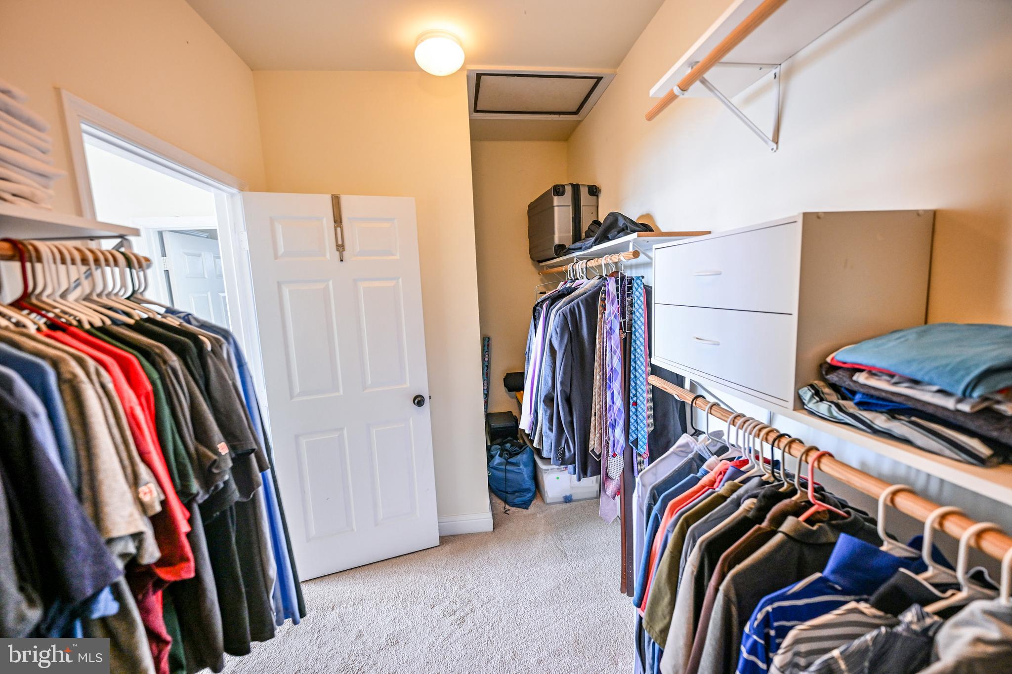 8727 Grape Arbor Way Odenton, MD 21113 - Photo 42 of 49 a view of walk in closet with clothes and shoes