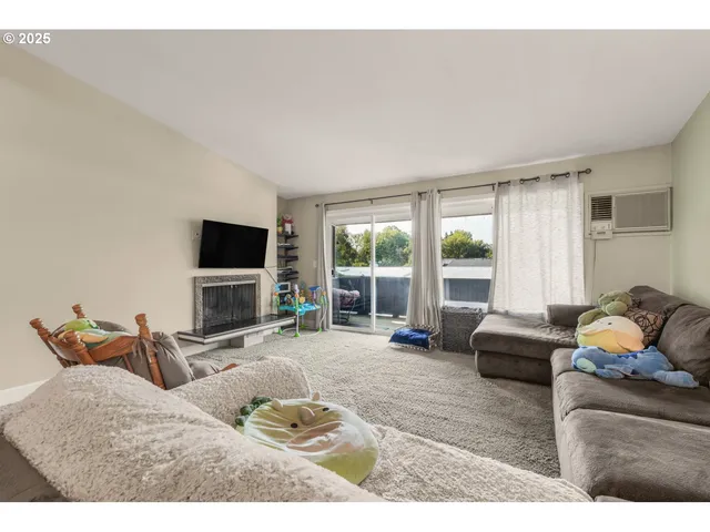 a bedroom with furniture and a flat screen tv