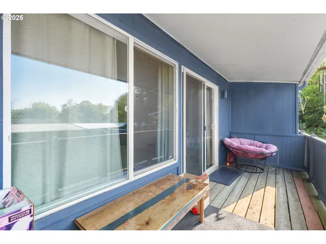 a view of a balcony with a dining table and chairs
