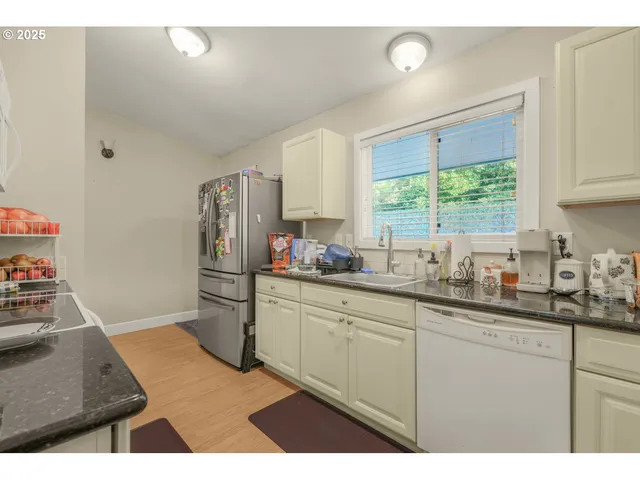 a kitchen with a sink stove and refrigerator