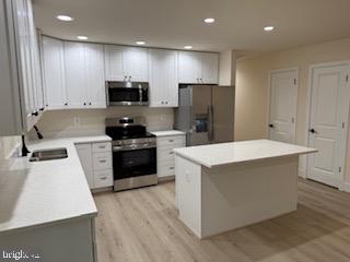 58 South Glebe Road Montross, VA 22520 - Photo 15 of 25 a kitchen with a sink a refrigerator a microwave and cabinets