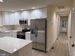 58 South Glebe Road Montross, VA 22520 - Photo 16 of 25 a kitchen with a refrigerator a stove top oven a sink and cabinets
