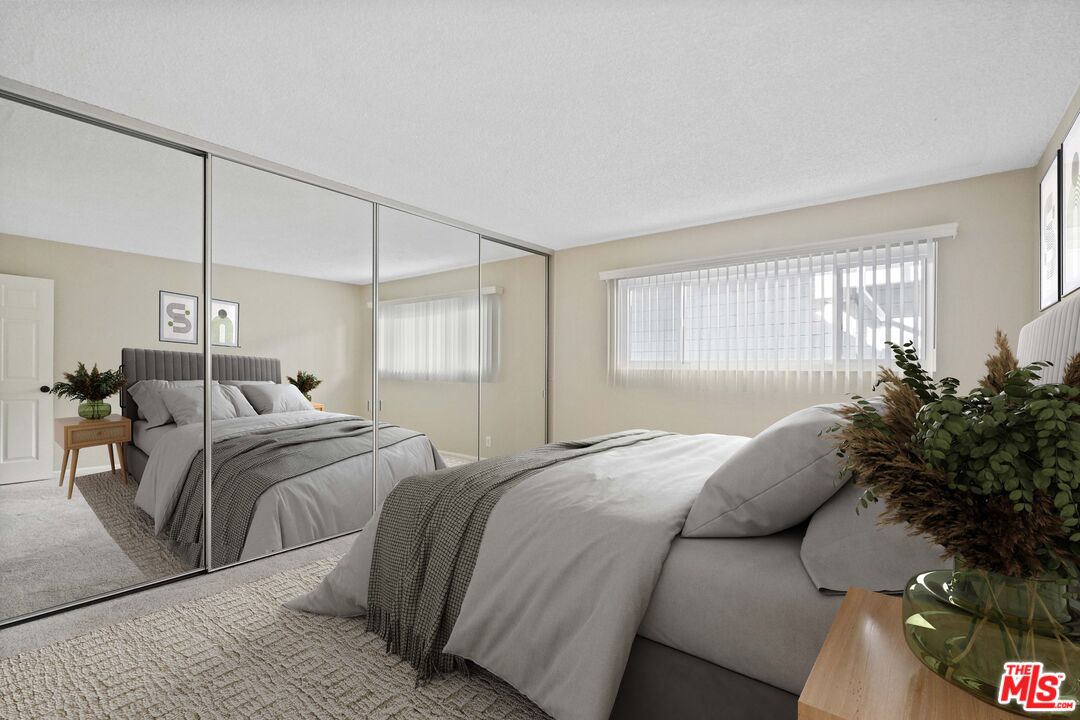 18000 Coastline Drive, Unit 8 Malibu, CA 90265 - Photo 12 of 26 a bed room with a bed and a potted plant