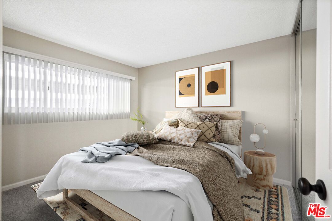 18000 Coastline Drive, Unit 8 Malibu, CA 90265 - Photo 17 of 26 a bedroom with a bed and a window