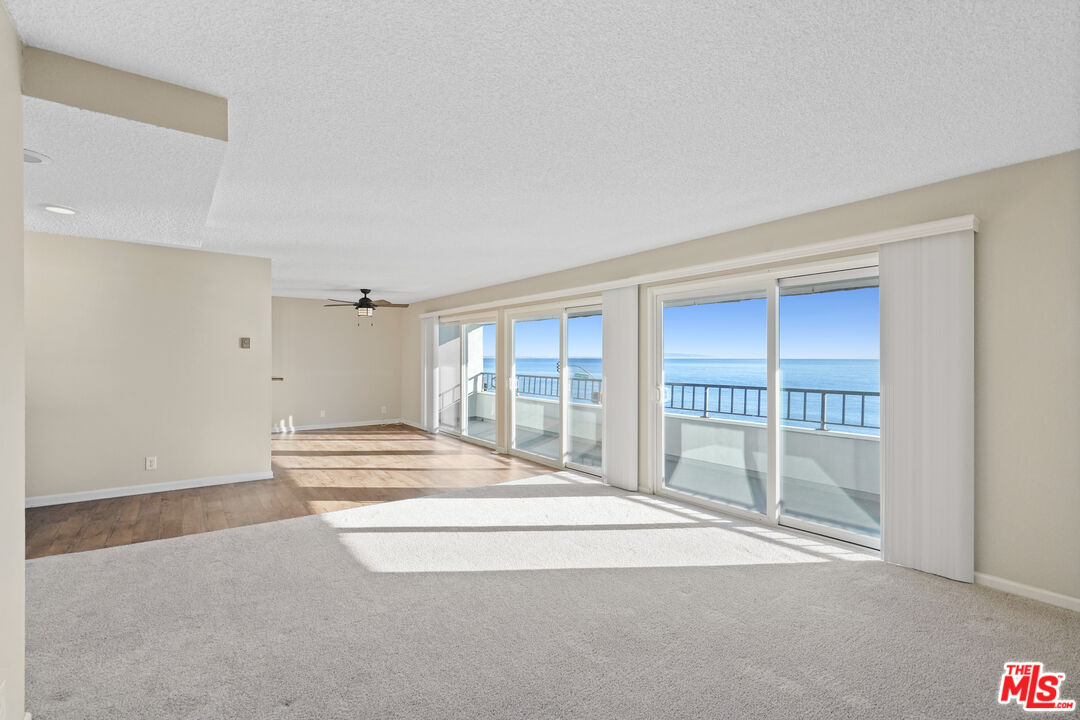 18000 Coastline Drive, Unit 8 Malibu, CA 90265 - Photo 4 of 26 a spacious bedroom with a bed and a large window