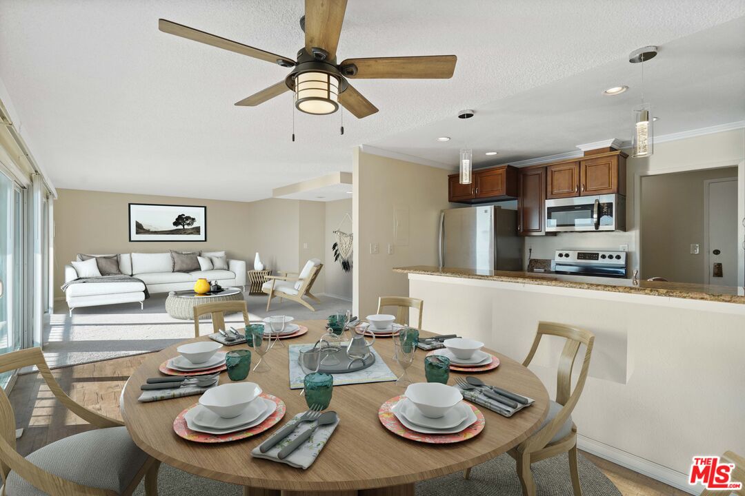 18000 Coastline Drive, Unit 8 Malibu, CA 90265 - Photo 5 of 26 a dining room with furniture a table and kitchen view
