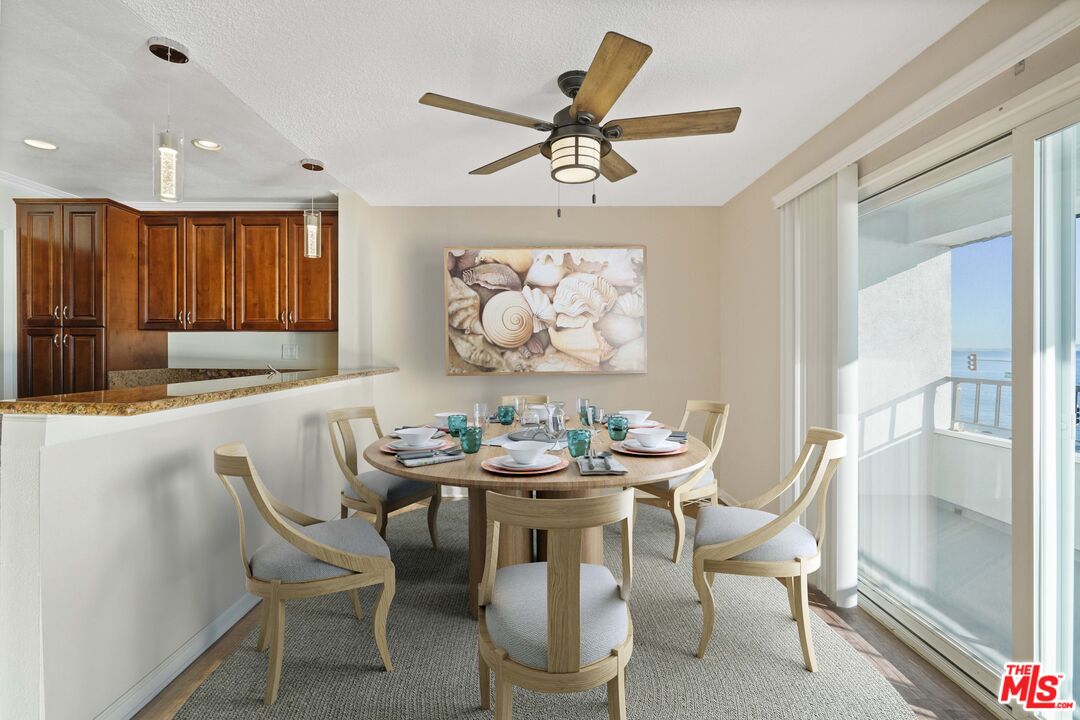 18000 Coastline Drive, Unit 8 Malibu, CA 90265 - Photo 6 of 26 a dining room with furniture a rug and a chandelier