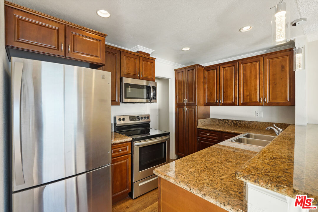 18000 Coastline Drive, Unit 8 Malibu, CA 90265 - Photo 8 of 26 a kitchen with stainless steel appliances granite countertop a refrigerator stove and sink