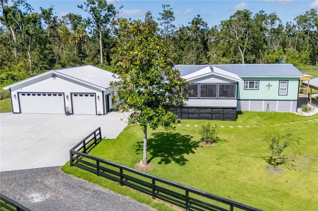 1175 Southwest 248th Avenue Steinhatchee, FL 32359 - Photo 14 of 54 a front view of a house with garden