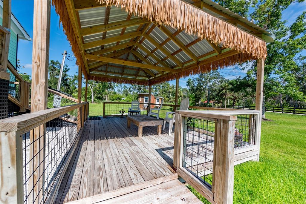 1175 Southwest 248th Avenue Steinhatchee, FL 32359 - Photo 17 of 54 a view of balcony with wooden floor and outdoor seating