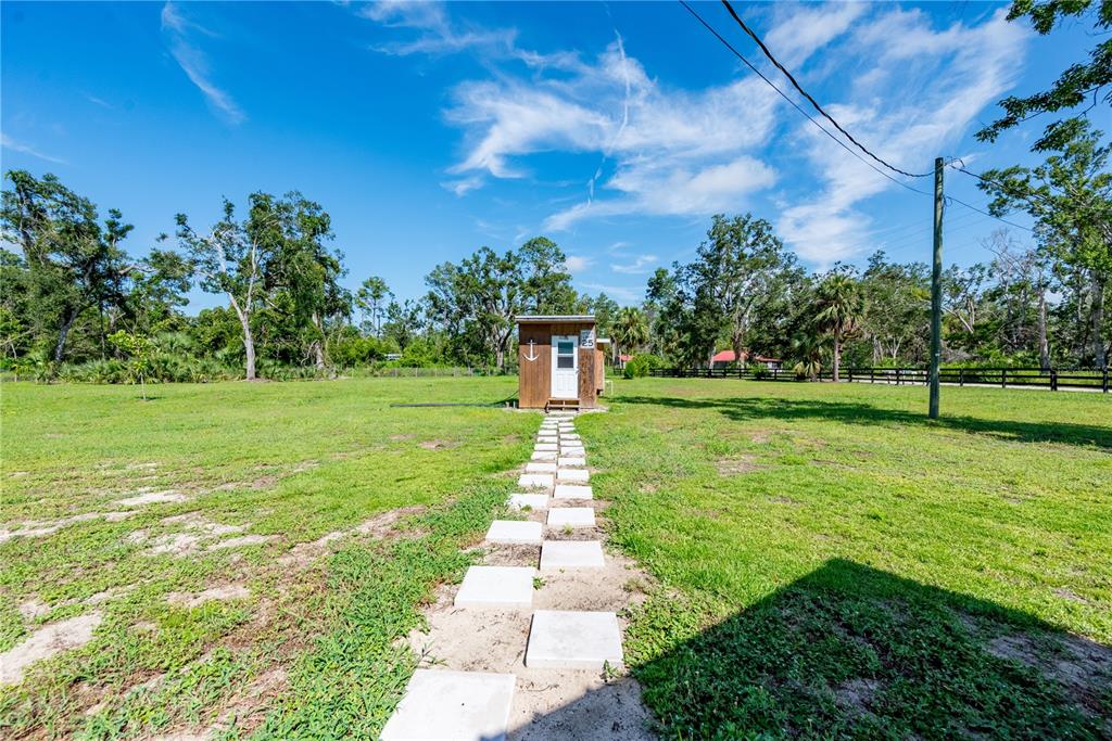 1175 Southwest 248th Avenue Steinhatchee, FL 32359 - Photo 19 of 54 a front view of a garden with a fountain