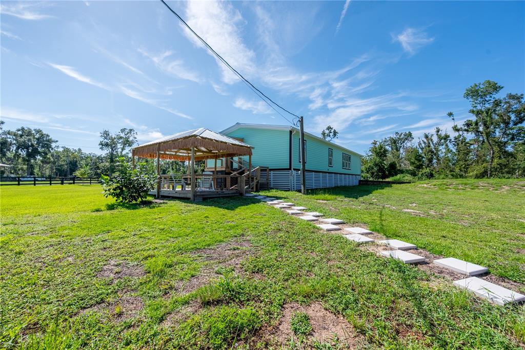 1175 Southwest 248th Avenue Steinhatchee, FL 32359 - Photo 20 of 54 a view of a big yard next to a house