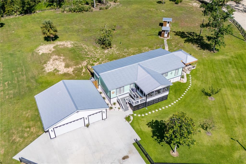 1175 Southwest 248th Avenue Steinhatchee, FL 32359 - Photo 21 of 54 an aerial view of a house with a garden and lake view